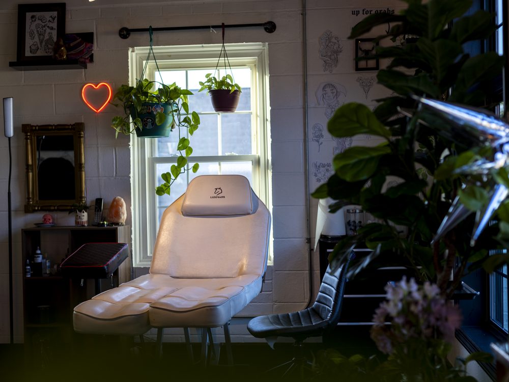 The Dawnbringer front desk with warm neon and house plants