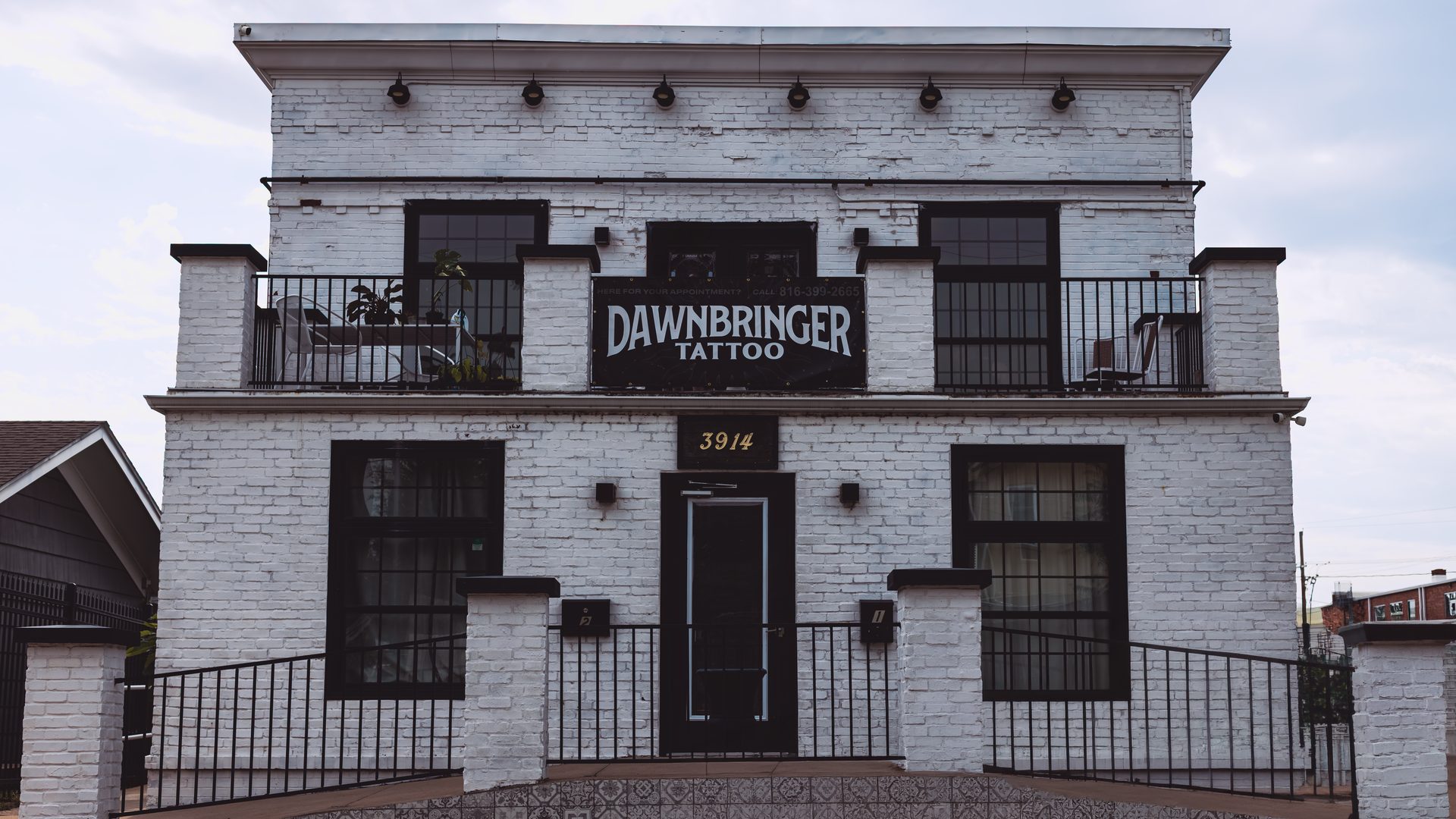 The white-brick Dawnbringer Tattoo building at 3914 Washington in Westport KC